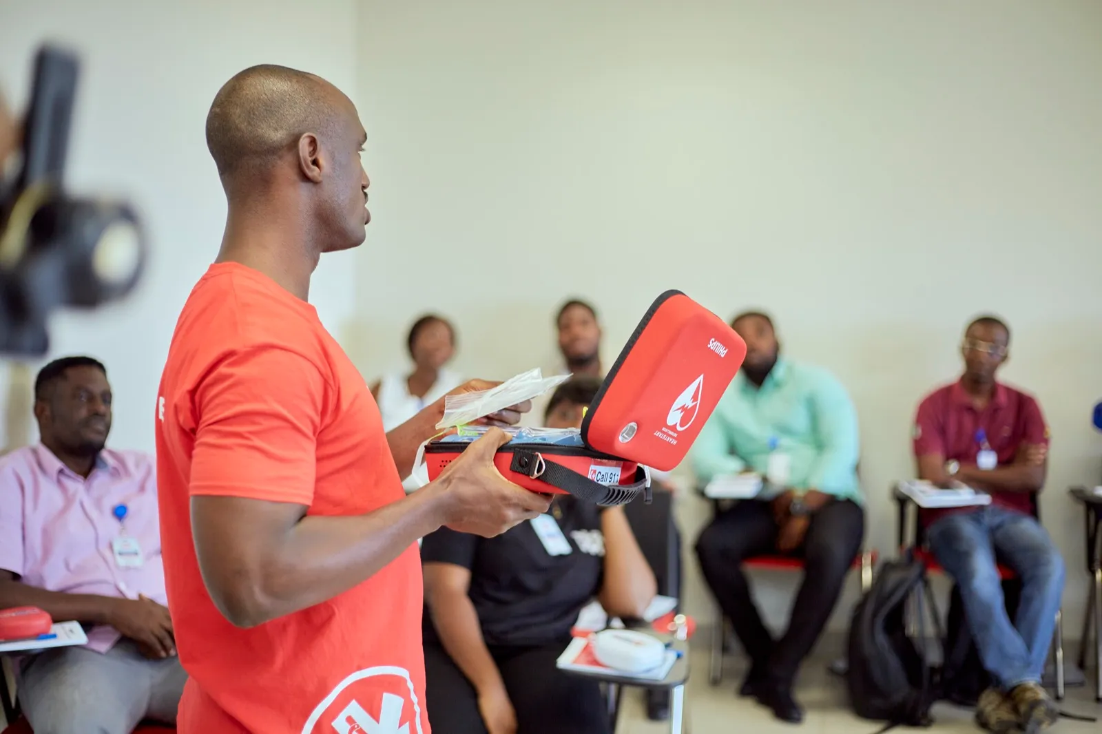 Participant learning AED operation during an emergency response training class
