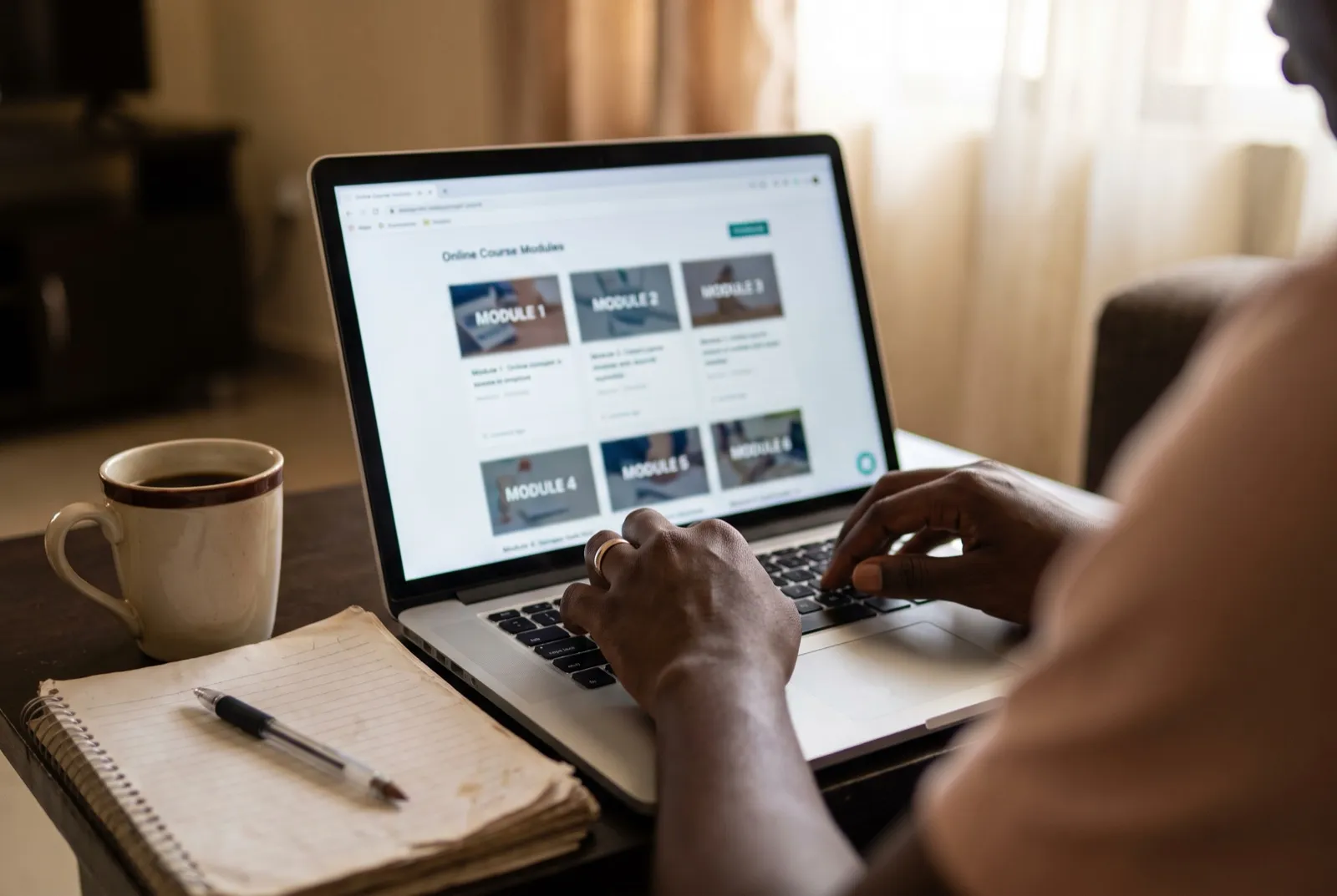A learner browsing an online course dashboard on a laptop